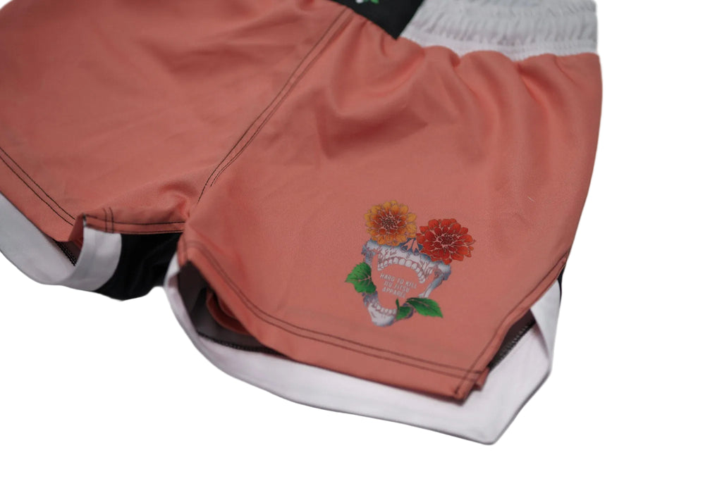 Pink shorts with floral embroidery on a white background