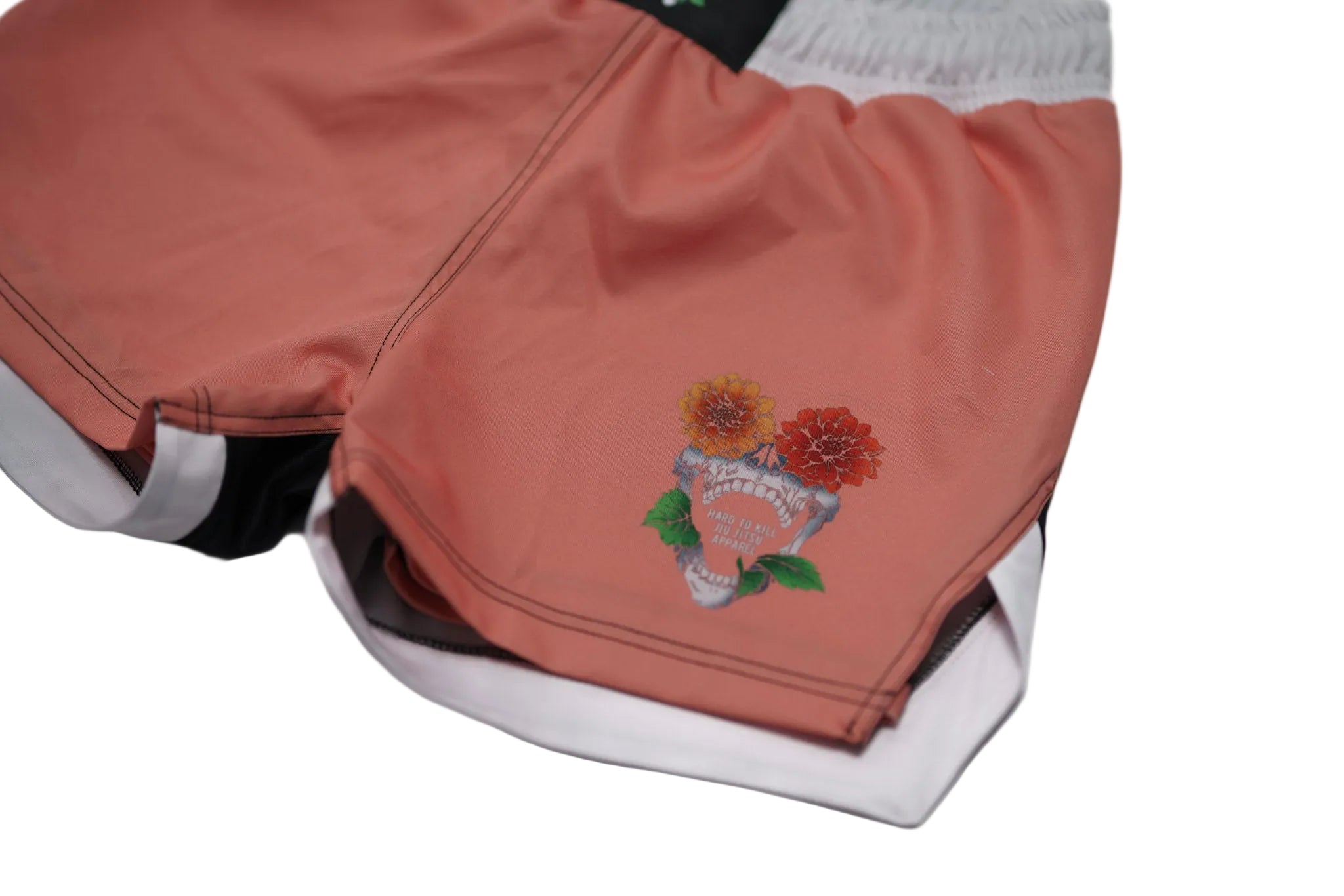 Pink shorts with floral embroidery on a white background